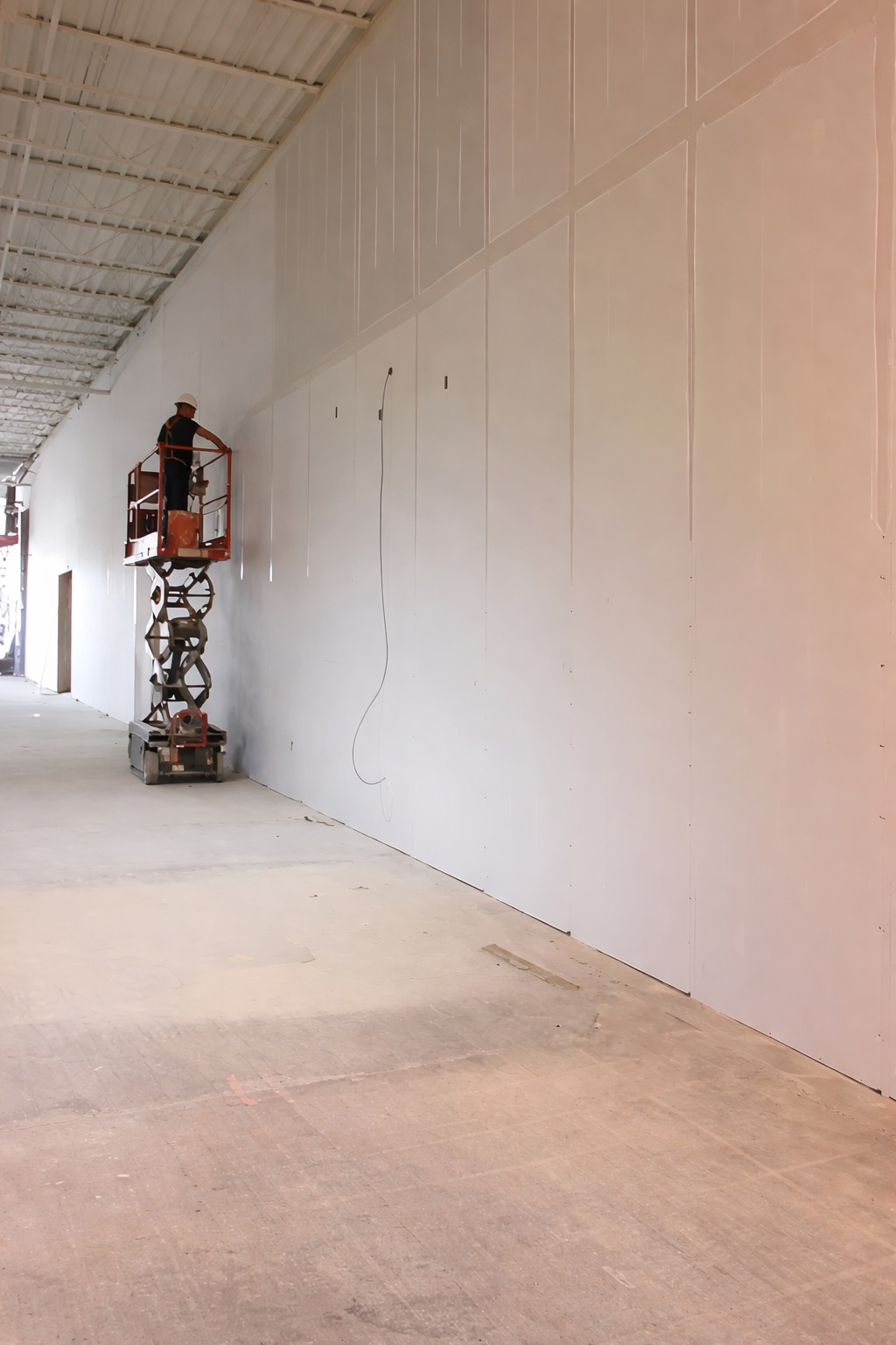 Boarding a high warehouse wall from a scissor lift